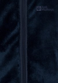 Navy fleece jacket with a smooth texture, featuring a front zipper and a small embossed logo on the upper left side.