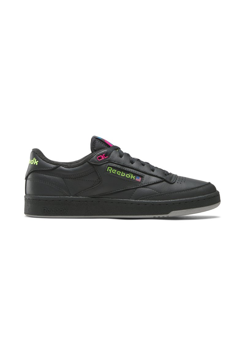 Black leather sneaker with a low-top design, featuring vibrant pink and green Reebok branding, textured side panels, and a rubber sole.