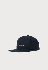 Black flat-brim cap with panel stitching and white embroidered text reading "SCOTT" on front left side.