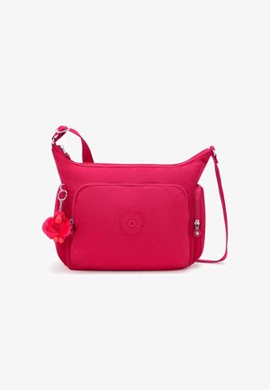 Rosa Crossbody-Tasche aus Stoff mit strukturierter Oberfläche, Reißverschluss, Vordertasche und einem schlüsselanhänger in Form eines Affen. Mit verstellbarem Riemen.