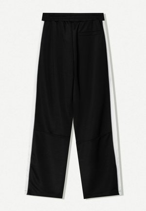 Black athletic pants made of smooth fabric with a loose fit. Features white side stripes and a back pocket on the right side.