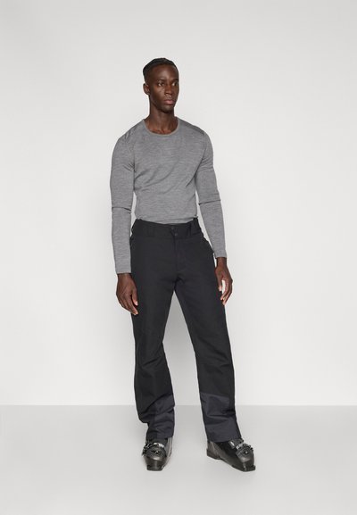 Gray long-sleeve shirt and black pants with a smooth texture. Pants have a fitted waist and wider legs, complemented by black footwear.