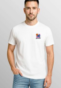 White cotton t-shirt featuring a small multicolored logo with a palm tree and the word "Neverless" on the left chest area.