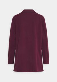 Maroon long-sleeve jacket with a collar, smooth texture, and a straight cut. Features a back vent for ease of movement.