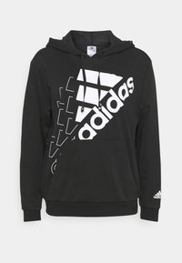 Sweat à capuche noir avec une poche avant, arborant un grand logo Adidas blanc et un design graphique diagonal blanc sur le haut devant.
