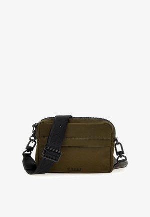 Olive green crossbody bag with a zippered closure, nylon material, black adjustable strap, and subtle logo detailing on the front.