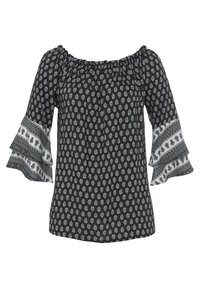 Blouse noire à épaules dénudées avec des motifs blancs élaborés et des manches volantes avec des accents supplémentaires à motifs. Tissu léger.