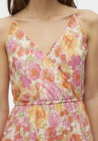 Floral dress with a wrap design, featuring vibrant pink, orange, and green flowers on a light background. Adjustable spaghetti straps.