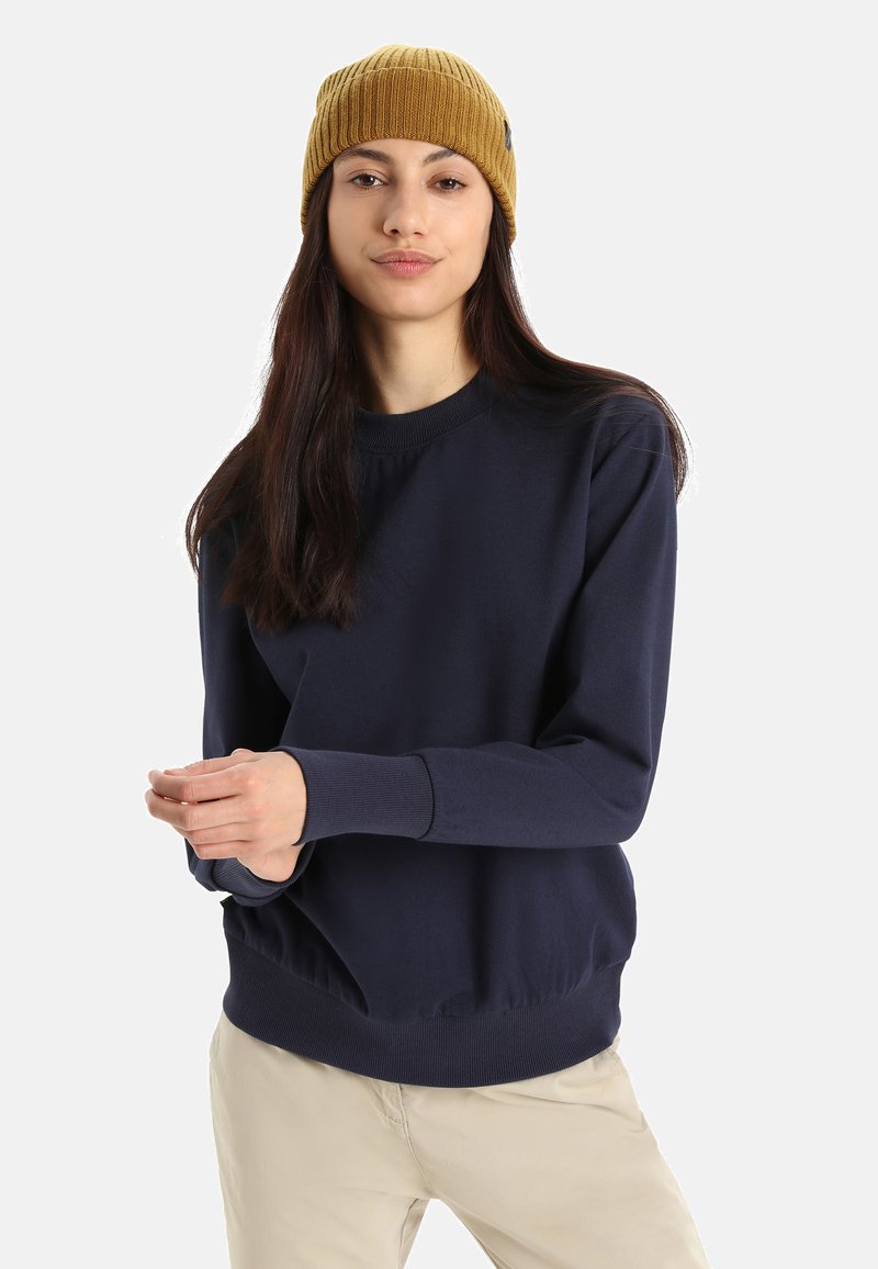 Felpa navy con polsini e orlo a costine, abbinata a un berretto a costine giallo. Tessuto liscio, vestibilità comoda, design minimale.