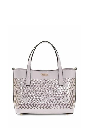 Lavender tote bag with lattice and floral cutouts, dual handles, and gold "GUESS" logo on upper front panel.