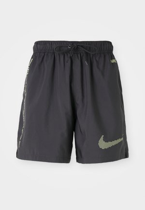 Black lightweight swim shorts with an elastic waistband, drawstring, and neon yellow Nike logo. Features side pockets and reflective accents.