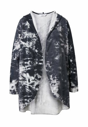 Lång huva jacka i tie-dye mönster, med nyanser av svart och vitt. Tillverkad av lätt tyg med lös passform och rundad nederkant.