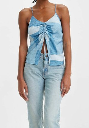 Light blue patterned camisole top with adjustable straps, featuring a gathered front design and a loose fit. Worn with light denim jeans.