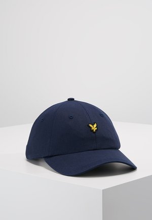 Marineblaue Baseballmütze aus Baumwolle, mit einem gebogenen Schirm, sechspaneligem Design und einem goldenen, gestickten Adlerlogo auf der Vorderseite.