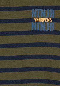 Green and navy striped t-shirt with "NINJA SHARPENS NINJA" text in blue and orange. Cotton material, soft texture, round neckline.