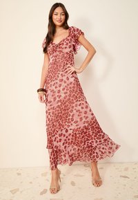 Maxi-jurk van lichtgewicht, doorschijnende stof met een roze en bordeaux luipaardprint. Heeft zwierige mouwen en een gerimpelde zoom.