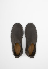 Bottines en daim grises avec des panneaux latéraux en élastique et un bout arrondi. Comprend une semelle texturée et une couture contrastante autour des bords.