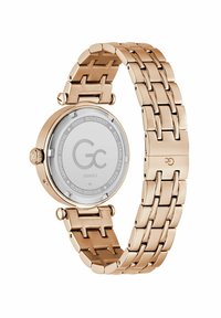 Złoty stalowy zegarek z okrągłą kopertą i gładkim paskiem. Posiada białą tarczę, szafirowe szkło i szwajcarski mechanizm.