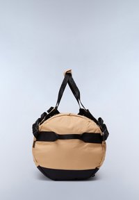 Round, beige and black bag with a padded exterior, dual black handles, adjustable straps, and a smooth texture. Features a prominent seam detail.