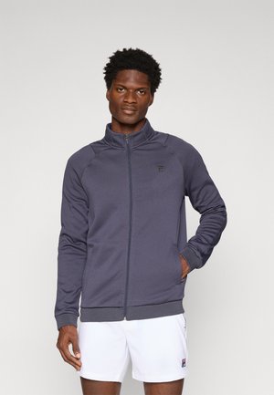 Marineblauwe zip-up jas met een gestructureerd patroon, hoge kraag en zijzakken. Heeft een klein logo op de linkerkant van de borst.
