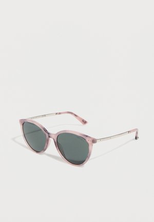 Pink translucent round sunglasses with dark lenses and thin metallic arms on a white background.