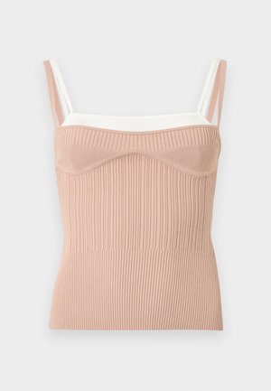 Ujjatlan bordázott kötött felső formázott kosarakkal, bézs és fehér dupla pántokkal, testhezálló megjelenésre tervezve.