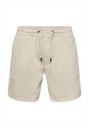 Lyse beige svømmeshorts laget av teksturert stoff, med elastisk midje og snor, samt subtile sidesømmer.