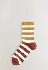Ribbed socks featuring alternating brown and beige stripes with a solid brown toe and cuff. Made from soft, textured fabric.