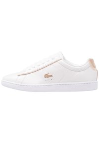 White leather sneakers with a smooth texture, rose gold accents, classic lace-up design, and a white rubber sole. Features logo on side.
