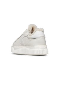 White textured leather sneaker with thick ribbed sole and plush fur lining visible at the ankle collar, angled to show the back and side.