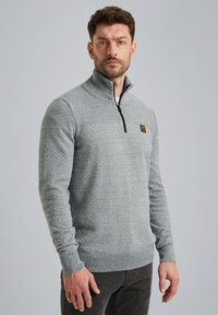 Lichtgrijze sweatshirt met ritssluiting in een gestructureerd breisel. Voorzien van een zwarte rits en een klein geel logo op de borst. Normale pasvorm.