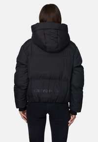 Giubbotto puffer nero con cappuccio, caratterizzato da un design trapuntato, polsini elastici e la scritta "CODE FOR NOTHING" embossata sul retro.