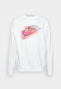Vit sweatshirt med rund halsringning, prydd med en svart Nike-logga och rosa grafiska detaljer. Tillverkad av mjukt material med ribbade muddar och fåll.