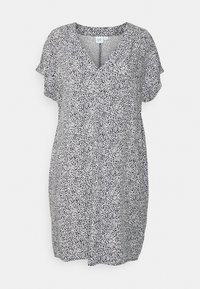 Robe à manches courtes noire et blanche avec un col en V, présentant un motif de points dispersés et une coupe décontractée. Tissu léger.