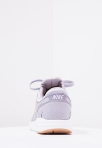 Nike-sneakers i ljuslila mesh-material med texturerade sidor, vadderad krage och vit sula med gummiröda detaljer.