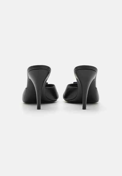 Black leather high-heeled mules with a sleek silhouette, pointed toe, and a smooth texture. Features a thin stiletto heel and open back design.