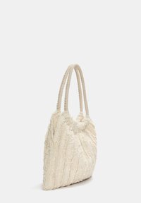 White textured handbag with plush fabric, featuring braided handles, a soft, ruffled design, and vertical stripe patterns.