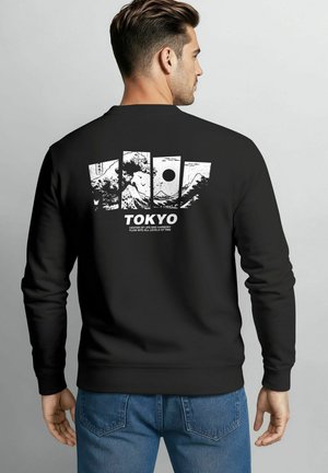 Black sweatshirt with a crew neckline featuring a white graphic design of mountains and a sun, along with the text "TOKYO."