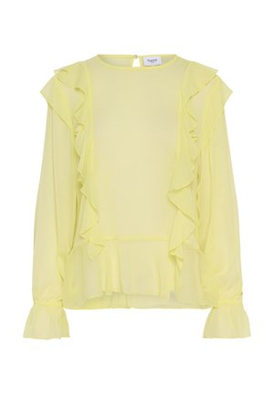 Keltainen sifonkipaita, jossa on röyhelökoristeet edessä ja hihoissa, pyöreä pääntie ja nappikiinnitys takana.