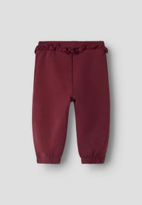 Bordowe spodnie dresowe z elastyczną talią i zbieranymi mankietami. Wykonane z miękkiego materiału o gładkiej fakturze. Bez kieszeni.
