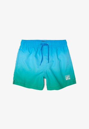 Short de bain avec un dégradé bleu-vert, taille élastique, cordon bleu, poches latérales et un petit patch palmier sur la jambe.