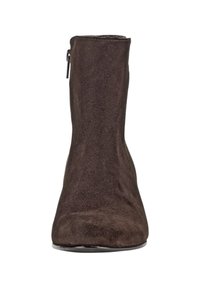 Brown suede ankle boot with a tapered silhouette, round toe, side zipper, and smooth texture. Minimalist design with no visible embellishments.