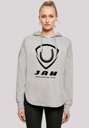 Grau geripptes Sweatshirt mit lockerer Passform. Auf der Vorderseite befindet sich ein großes schwarzes Logo und der Text "JAM SHOWJUMPING TEAM". Weicher Stoff.
