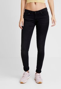 Jeans negros ajustados con un diseño ceñido, que incluyen bolsillos delanteros, cierre de botón y una textura de denim suave y lisa.