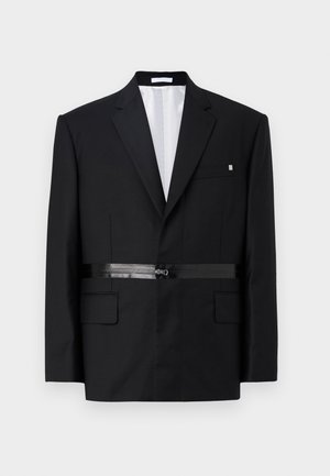 Black tailored blazer with a slim fit, structured shoulders, satin belt detail, and two front pockets. Lined interior in white.
