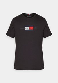 Black short-sleeve t-shirt with Tommy Hilfiger logo in red, white, and navy blue centered on the chest.
