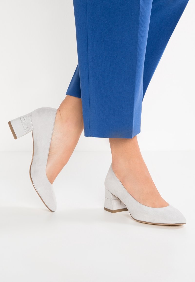Chaussures à talons hauts en daim gris avec un bout arrondi et un talon en bloc rectangulaire. La texture extérieure est douce, avec une doublure intérieure lisse.