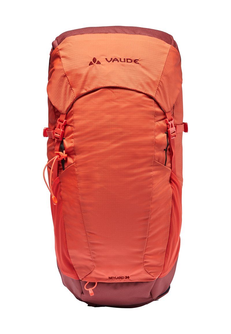 Sac à dos orange avec une finition lisse, poches latérales en mesh, bretelles réglables et un accent plus sombre à la base, arborant un logo VAUDE.