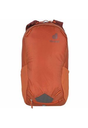 Orange fabric backpack with a rounded shape, featuring a logo, side mesh pockets, and a zipper closure at the bottom.