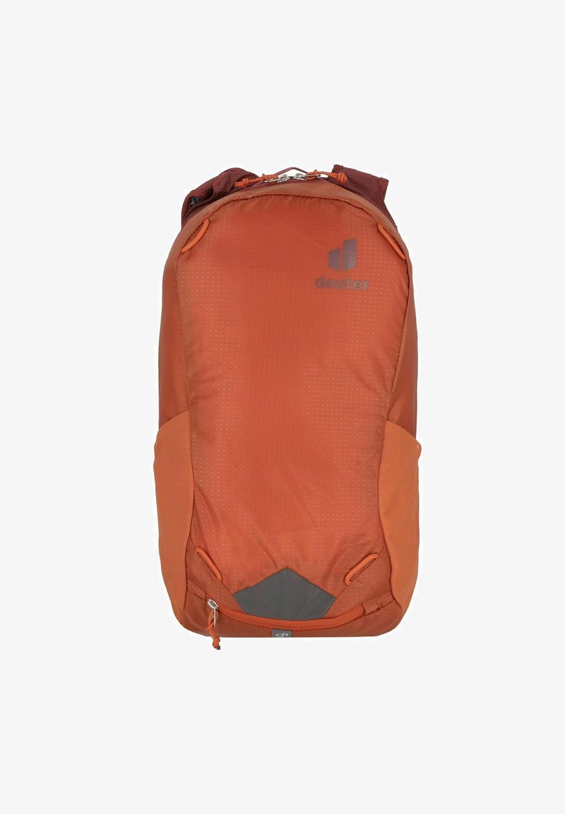 Orange fabric backpack with a rounded shape, featuring a logo, side mesh pockets, and a zipper closure at the bottom.